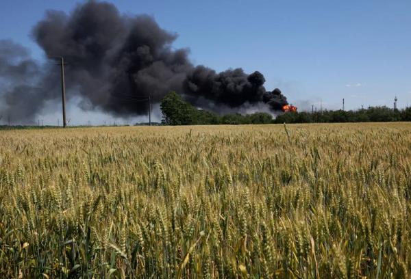 A fire from a gas processing plant co<em></em>ntinues to burn behind a field of wheat after it was hit by shelling a few days earlier in Andriivka, in the Kharkiv region. Reuters
