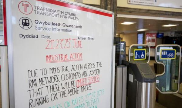 A sign pointing out industrial action is taking place on June 21, 23 and 25 near ticket barriers at Cardiff Central train station