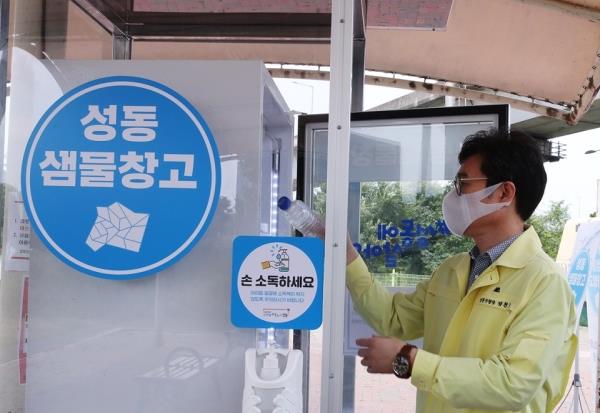 Jeong Won-oh, Mayor of Seo<em></em>ngdong District, takes a bottle of water out of a refrigerator which has been set up as part of his district‘s scheme to counter the heat. (Seo<em></em>ngdong District)