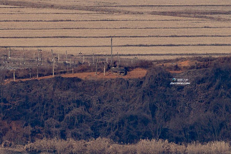This photo, taken from a South Korean observation tower in Paju, north of Seoul, shows North Korean soldiers moving along a barbed wire fence in the western border town of Kaepung, North Hwanghae Province, on Wednesday, when North Korea launched an apparent ballistic missile toward the East Sea at around 8:10 a.m. from a land-ba<em></em>sed platform. (Yonhap)