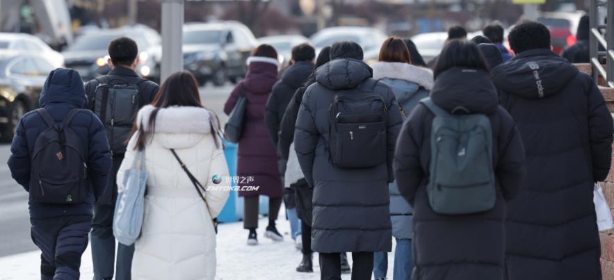 People go to work wearing padded jackets as cold weather grips Seoul on Tuesday. (Yonhap)
